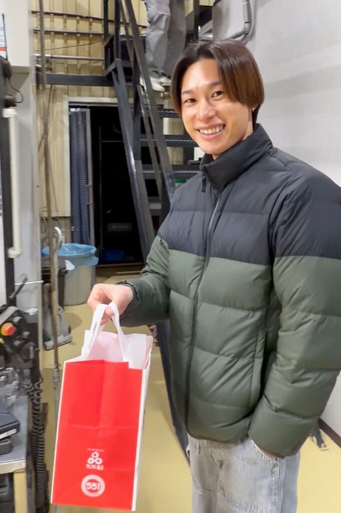 551の蓬莱を持って帰るN君。株式会社テクノファム